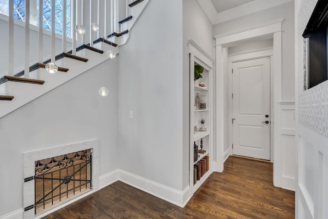 interior space with stairway, baseboards, and dark wood finished floors