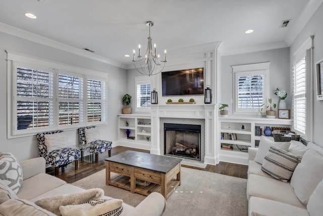 living area with plenty of natural light, visible vents, crown molding, and wood finished floors