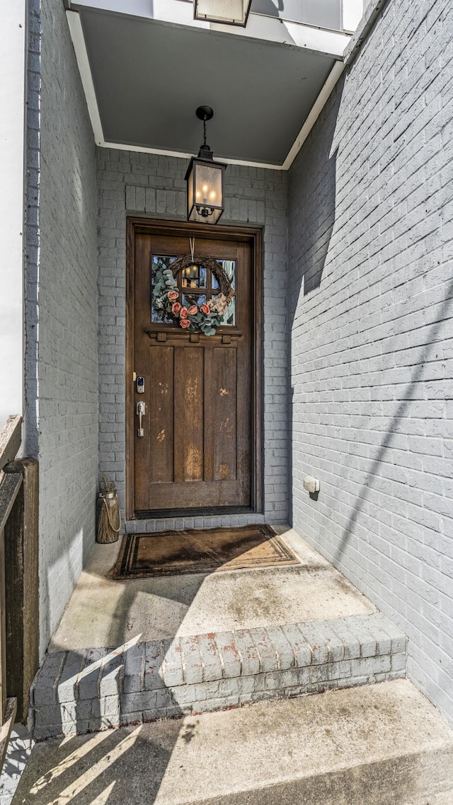 property entrance featuring brick siding