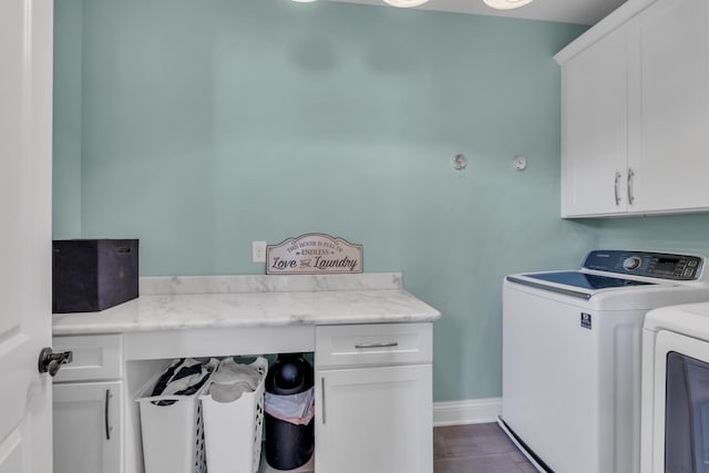 laundry room with washer and dryer, cabinet space, and baseboards