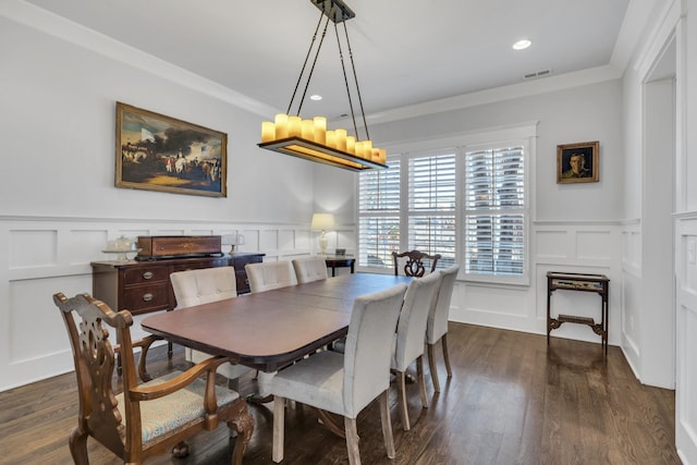 dining room featuring a decorative wall, dark wood-style flooring, and crown molding