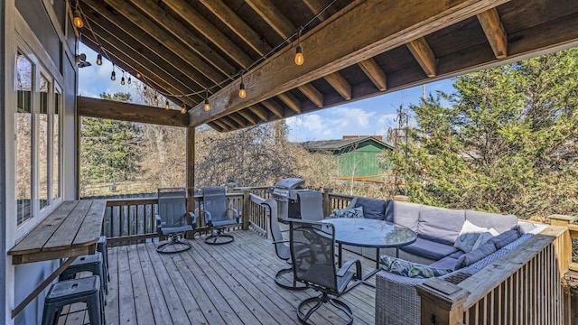 wooden terrace with outdoor dining space and outdoor lounge area