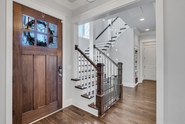 foyer entrance featuring recessed lighting, wood finished floors, visible vents, baseboards, and stairway