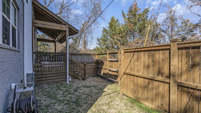 view of yard with fence and a wooden deck