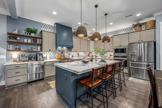 kitchen featuring gray cabinetry, appliances with stainless steel finishes, visible vents, and custom range hood