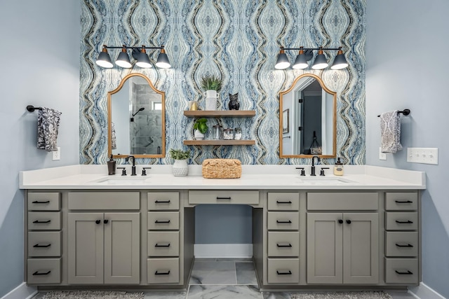 bathroom featuring marble finish floor, double vanity, and a sink