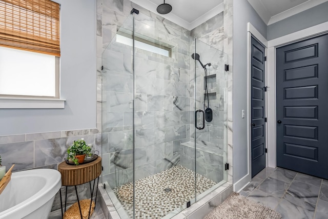 full bath with tile walls, a freestanding bath, marble finish floor, ornamental molding, and a shower stall