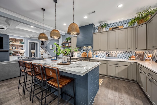 kitchen featuring dark wood-type flooring, gray cabinets, visible vents, and custom range hood