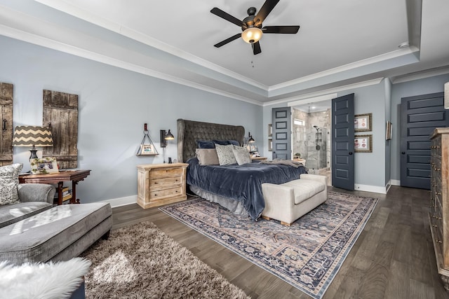 bedroom featuring wood finished floors, a raised ceiling, and baseboards