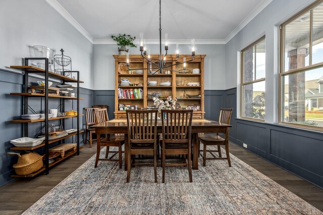 dining room featuring a wainscoted wall, wood finished floors, and crown molding