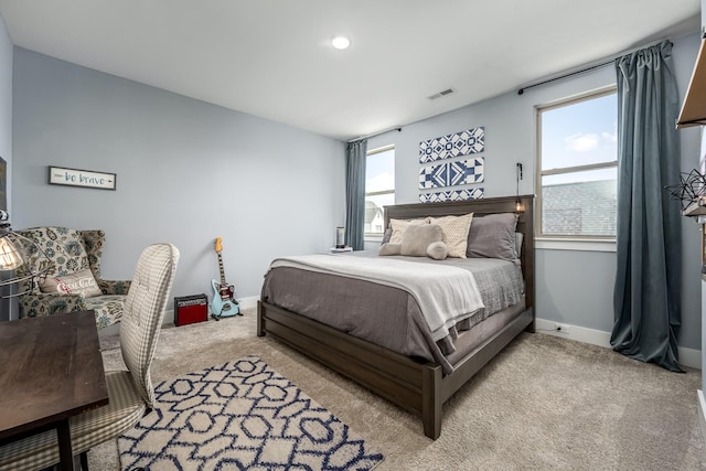 carpeted bedroom featuring visible vents and baseboards