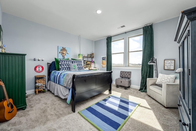 carpeted bedroom featuring baseboards and visible vents