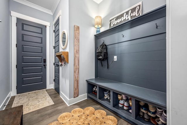 mudroom featuring baseboards, ornamental molding, and dark wood finished floors