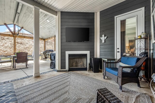 view of patio / terrace featuring a large fireplace and outdoor dining space