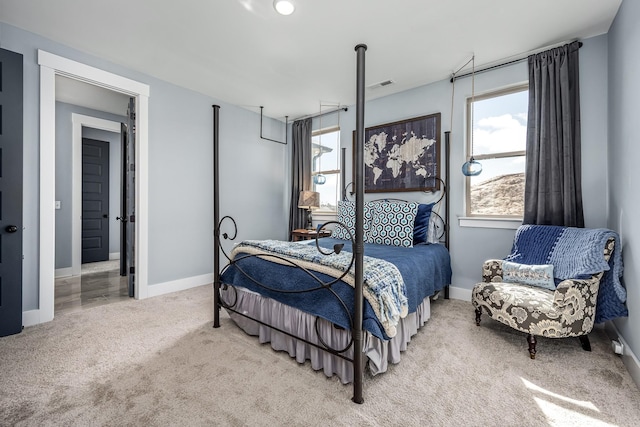 bedroom with carpet floors, visible vents, baseboards, and multiple windows