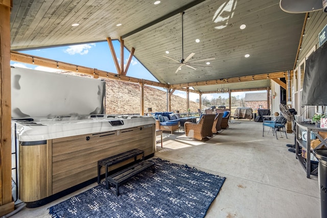 view of patio featuring ceiling fan, a hot tub, and an outdoor hangout area