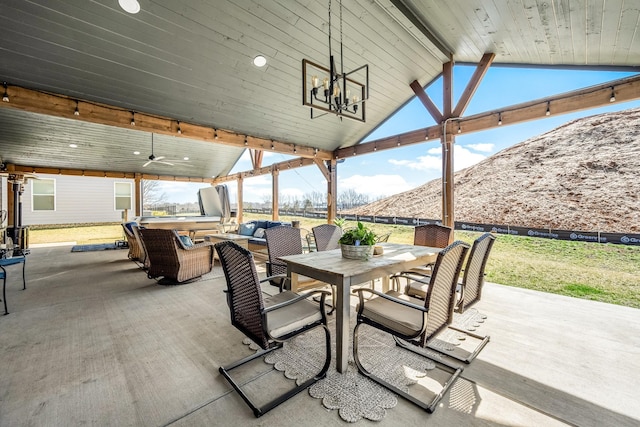 view of patio / terrace featuring a mountain view, outdoor dining area, outdoor lounge area, and a ceiling fan