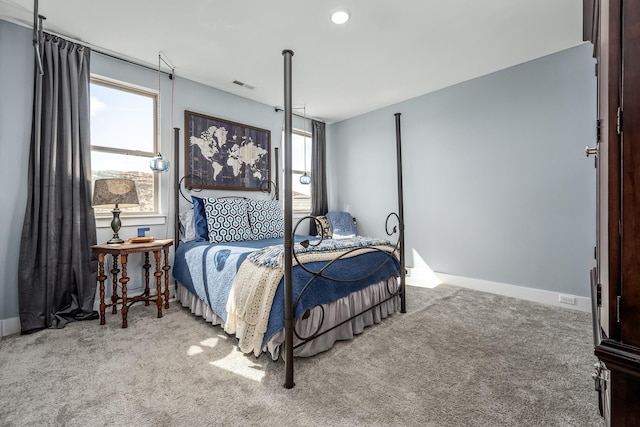 carpeted bedroom featuring multiple windows and visible vents