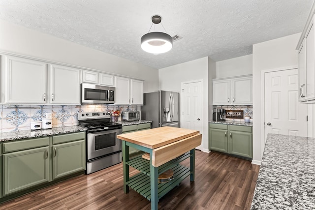 kitchen featuring dark wood-style floors, appliances with stainless steel finishes, white cabinets, and green cabinetry