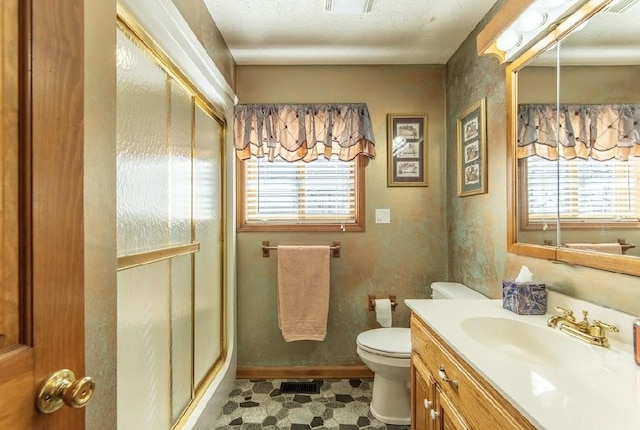 bathroom featuring a wealth of natural light, toilet, vanity, and a shower stall