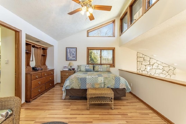 bedroom featuring high vaulted ceiling, light wood-type flooring, a textured ceiling, and baseboards