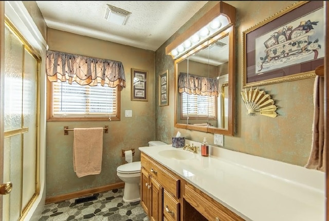 full bathroom featuring a stall shower, visible vents, toilet, a textured ceiling, and vanity