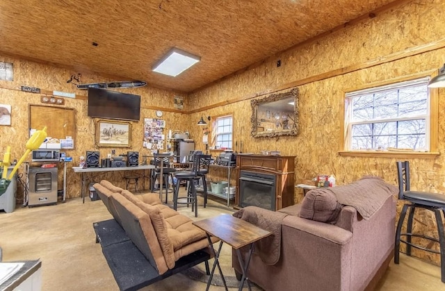 living room featuring concrete floors and a fireplace