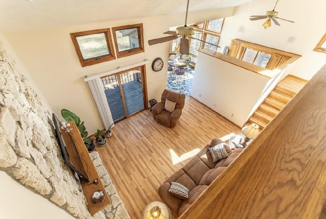 living area featuring ceiling fan, high vaulted ceiling, and wood finished floors