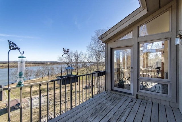 wooden terrace featuring a water view