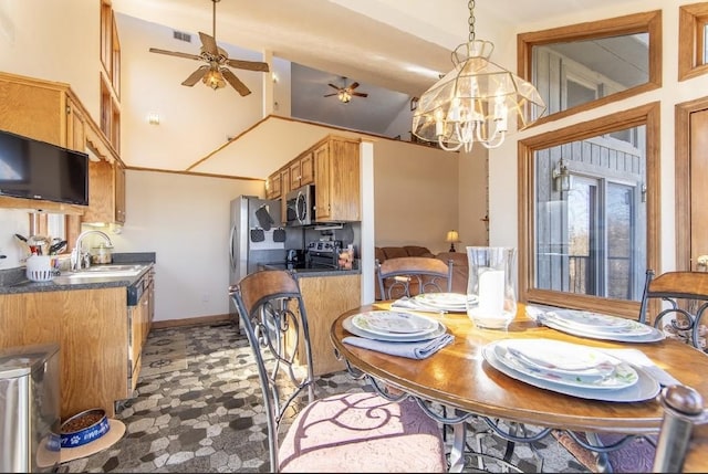 dining area featuring ceiling fan, visible vents, baseboards, and vaulted ceiling