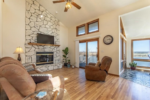 living room with plenty of natural light, a fireplace, and wood finished floors