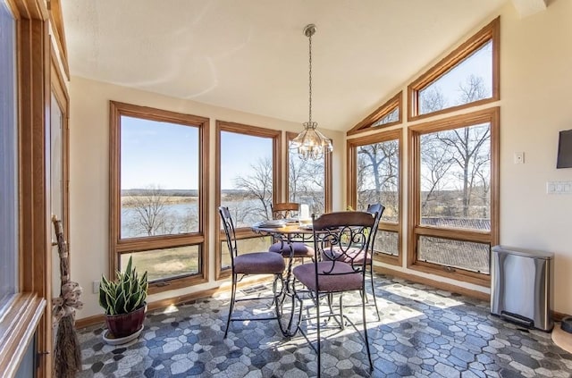 sunroom / solarium featuring lofted ceiling and a chandelier