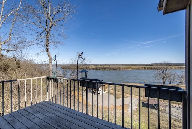 wooden terrace featuring a water view