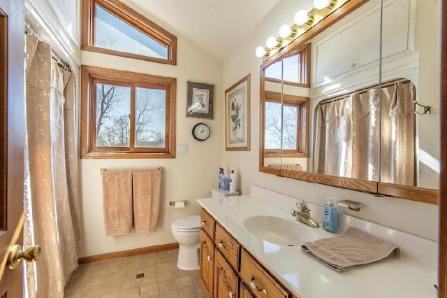 bathroom featuring baseboards, lofted ceiling, a shower with curtain, toilet, and vanity