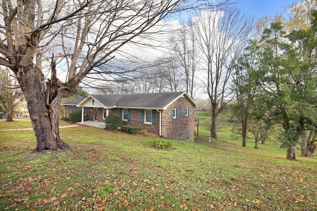 view of front of house with brick siding and a front yard