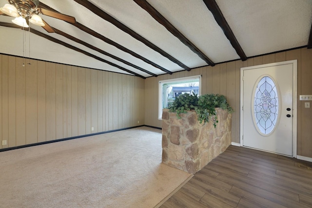 foyer entrance featuring lofted ceiling with beams and wood finished floors