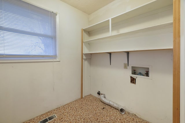 laundry area featuring laundry area, washer hookup, and visible vents