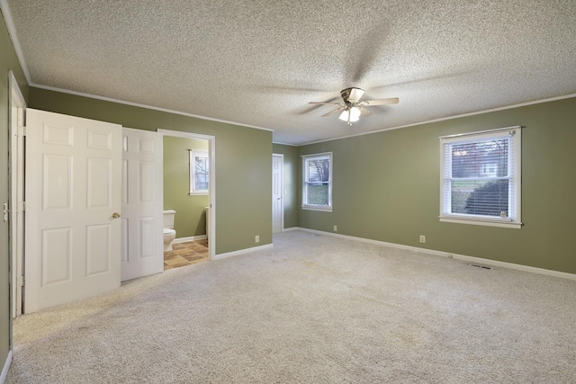 unfurnished bedroom with ornamental molding and carpet flooring