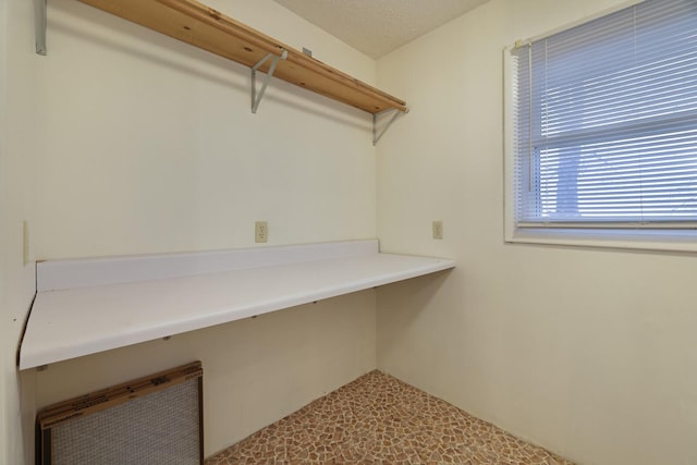 laundry room featuring a textured ceiling