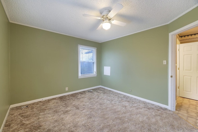 unfurnished room with a textured ceiling, carpet floors, a ceiling fan, baseboards, and ornamental molding