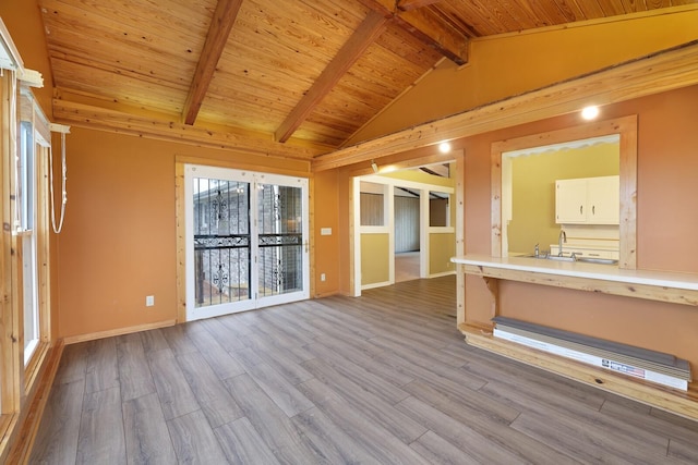 unfurnished room featuring lofted ceiling with beams, wooden ceiling, baseboards, and wood finished floors