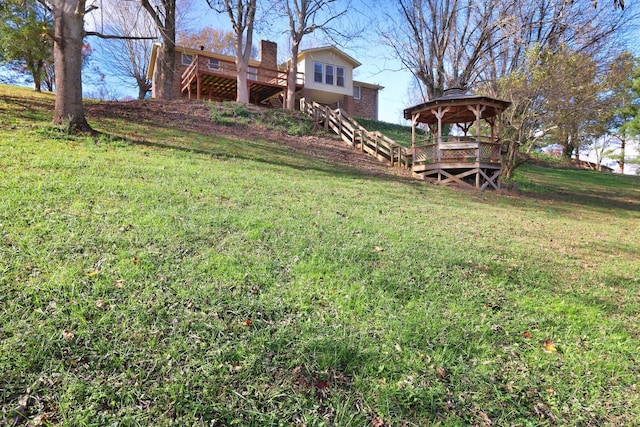 view of yard featuring stairs, a gazebo, and a wooden deck