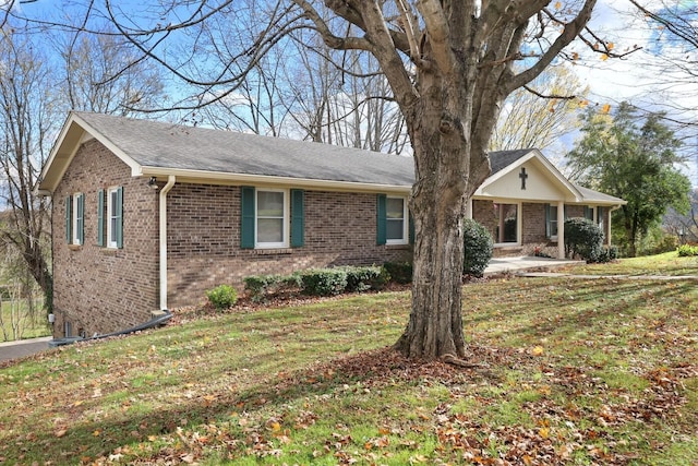 single story home with brick siding and a front lawn