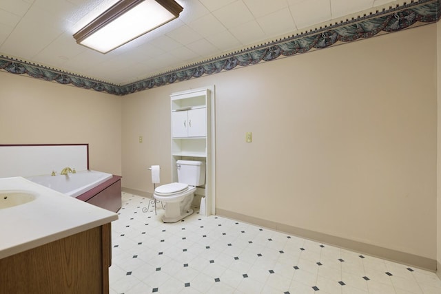 bathroom featuring toilet, tile patterned floors, baseboards, and vanity