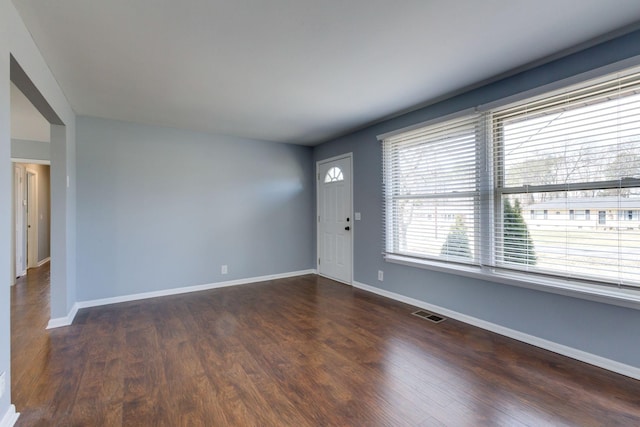 interior space with visible vents, baseboards, and wood finished floors