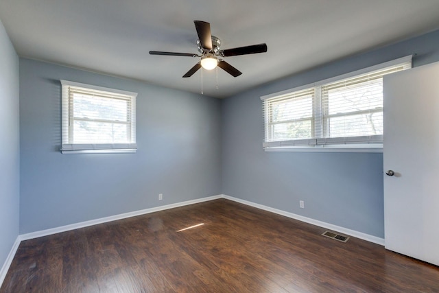 empty room with visible vents, baseboards, ceiling fan, and wood finished floors