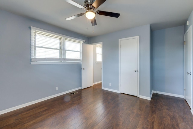 unfurnished bedroom featuring visible vents, ceiling fan, baseboards, and wood finished floors