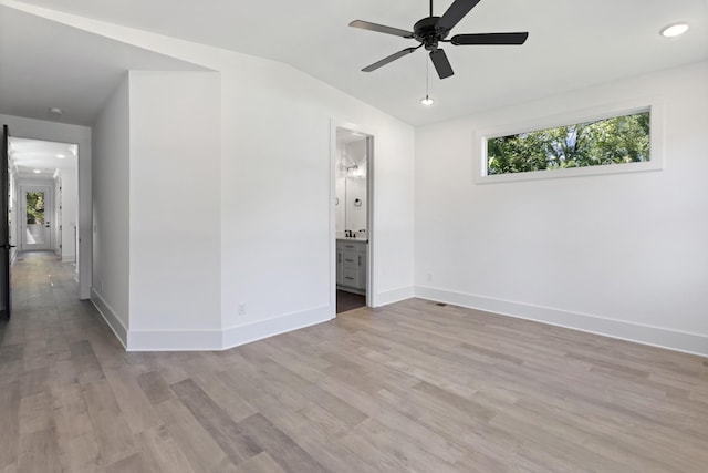 unfurnished bedroom with lofted ceiling, recessed lighting, baseboards, and wood finished floors