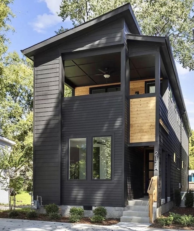 contemporary home with a ceiling fan, crawl space, and a balcony