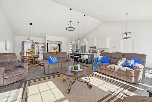 living area featuring a chandelier, recessed lighting, and high vaulted ceiling